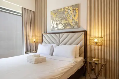 a hotel room with a bed with a towel on it at Stunning 2BR Full Burj Khalifa Views 5min walk to Dubai Mall in Dubai