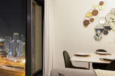 a dining room with a table and a view of a city at Stunning 2BR Full Burj Khalifa Views 5min walk to Dubai Mall in Dubai