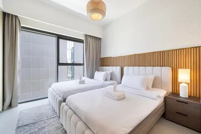 a hotel room with two beds and a window at Stunning 2BR Full Burj Khalifa Views 5min walk to Dubai Mall in Dubai