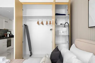a small room with a bed and a closet at Silkhaus New High Floor Studio In Business Bay in Dubai