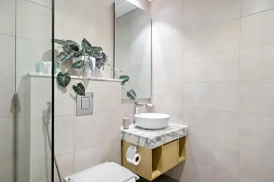 a bathroom with a toilet and a sink and a shower at Silkhaus New High Floor Studio In Business Bay in Dubai