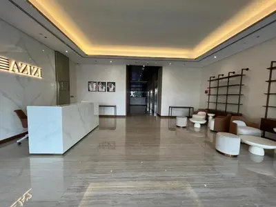 a lobby with white furniture in a building at Modern studio view Burj Khalifa in Dubai