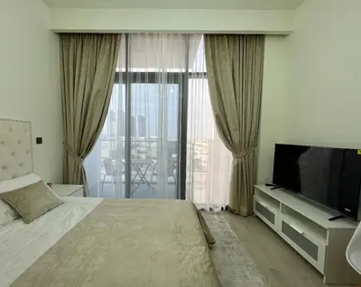 a hotel room with a bed and a television at Modern studio view Burj Khalifa in Dubai
