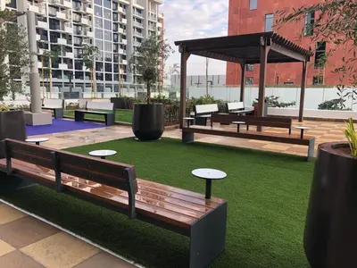 a park with benches and tables on the grass at Modern studio view Burj Khalifa in Dubai