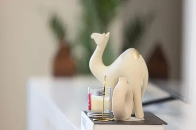 a figurine of a camel and a glass of candle at Stunning Burj and Fountain View - 2BR in Dubai