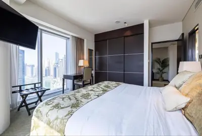a bedroom with a large bed and a large window at One bedroom apartment in JW Marriott Hotel Dubai Marina in Dubai