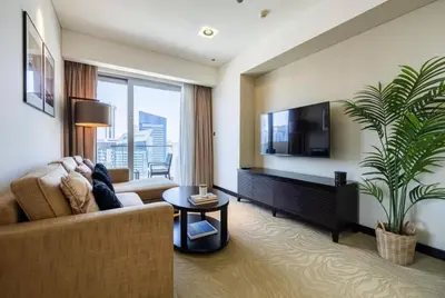 a living room with a couch and a tv at One bedroom apartment in JW Marriott Hotel Dubai Marina in Dubai