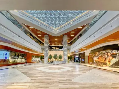 a large building with a lobby with a glass ceiling at First Class 1BR Modern & Stylish Living in Dubai