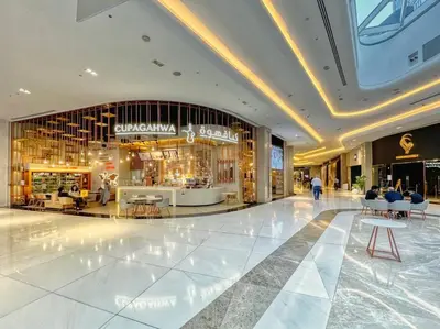 a large shopping mall with a person walking through it at First Class 1BR Modern & Stylish Living in Dubai