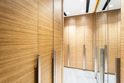 a hallway with wood paneled walls and doors at Dubai 2BR Flat, Marina Views, Pool Access, Parking, Walk to Mall in Dubai