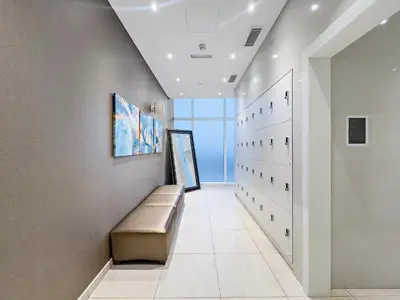 a hallway with a bench and a wall with a window at Dubai 2BR Flat, Marina Views, Pool Access, Parking, Walk to Mall in Dubai