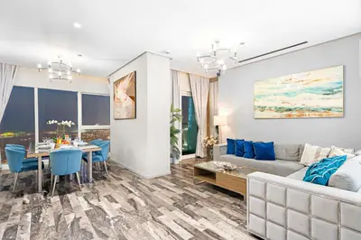 a living room with a couch and a table at Dubai 2BR Flat, Marina Views, Pool Access, Parking, Walk to Mall in Dubai
