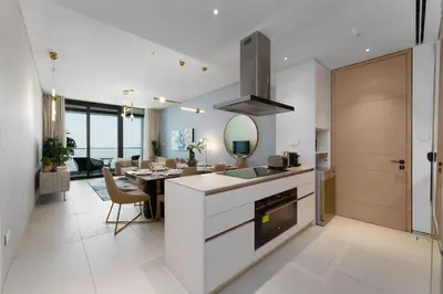 a kitchen and dining room with a dining table at Maison Privee - Luxury Living w/ Superb Sea Views in Address JBR in Dubai