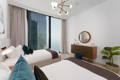 a hotel room with two beds and a window at Maison Privee - Luxury Living w/ Superb Sea Views in Address JBR in Dubai