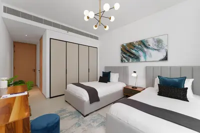a hotel room with two beds and a chandelier at Maison Privee - Luxury Living w/ Superb Sea Views in Address JBR in Dubai