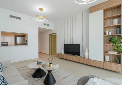a living room with a couch and a tv at Downtown Views 4702 in Dubai