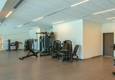 a gym with several tread machines in a room at Downtown Views 4702 in Dubai