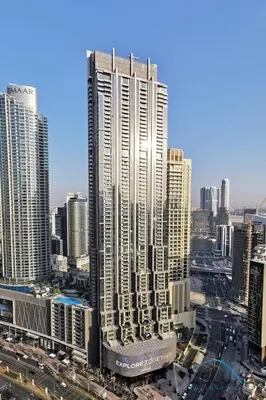 a tall building in a city with many buildings at Luxurious 2BR Apartment at Boulevard Point Downtown Dubai by Deluxe Holiday Homes in Dubai