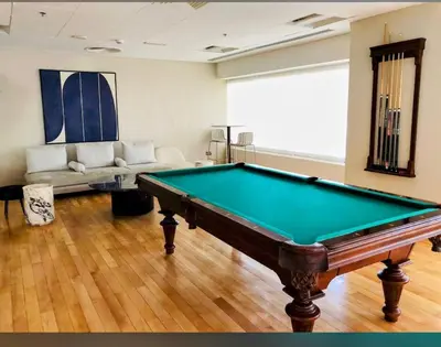 a living room with a pool table and a couch at Downtown Studio near Dubai Mall in Dubai