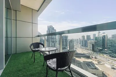 two chairs and a table on a balcony with a view at Downtown Studio near Dubai Mall in Dubai