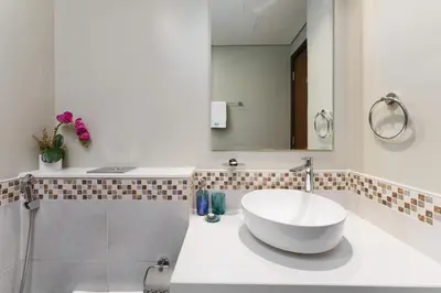 a bathroom with a white sink and a mirror at Contemporary Apartment with Burj Khalifa View in Dubai