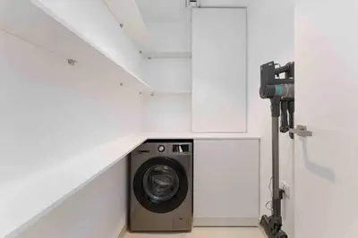 a washer and dryer in a white room at Beach stylish full sea view in Dubai
