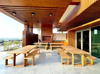 a restaurant with wooden tables and benches on a patio at Beach stylish full sea view in Dubai