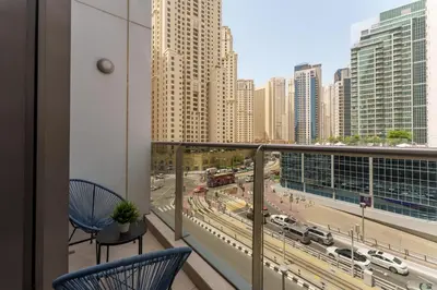 a balcony with two chairs and a view of a city at Elevated Living studio in Sparkle Tower- Suiteable in Dubai