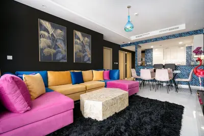 a living room with a couch and a table at Best Burj Khalifa View Balcony Apartment with 64th-Floor Infinity Pool in Paramount Hotel Midtown in Dubai