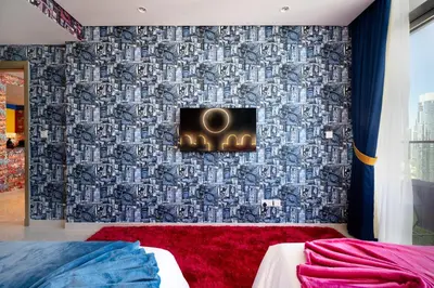 a bedroom with a wall with a wallpaper at Best Burj Khalifa View Balcony Apartment with 64th-Floor Infinity Pool in Paramount Hotel Midtown in Dubai