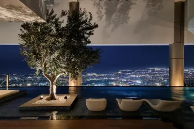 a tree on a table with a view of a city at Best Burj Khalifa View Balcony Apartment with 64th-Floor Infinity Pool in Paramount Hotel Midtown in Dubai