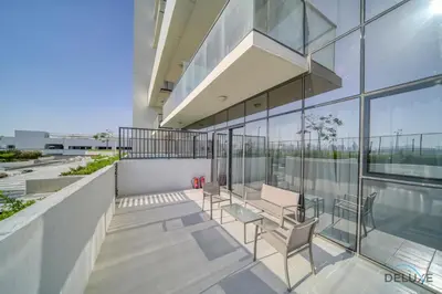 a balcony with chairs and tables on a building at Peaceful 1BR at Golf Vita A Damac Hills by Deluxe Holiday Homes in Dubai