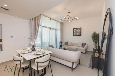 a living room with a couch and a table at Stylish 2BR Apartment at Dubai Hills with Pool Access By ĀYA Boutique in Dubai