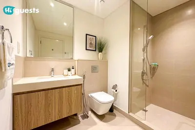 a bathroom with a sink and a toilet and a shower at HiGuests - Sky-High Luxury 2BR Apt in Downtown Views Dubai in Dubai