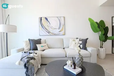 a living room with a white couch and a table at HiGuests - Sky-High Luxury 2BR Apt in Downtown Views Dubai in Dubai