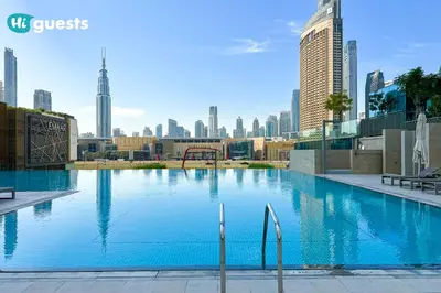 a large swimming pool with a city skyline in the background at HiGuests - Sky-High Luxury 2BR Apt in Downtown Views Dubai in Dubai