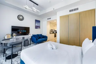 a hotel room with a bed and a desk at A Living - Luxury Studio Apartment in Aykon City Canal Views, Business bay in Dubai