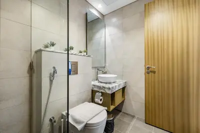 a bathroom with a toilet and a sink at A Living - Luxury Studio Apartment in Aykon City Canal Views, Business bay in Dubai