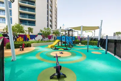 a playground with a slide and a play equipment at A Living - Luxury Studio Apartment in Aykon City Canal Views, Business bay in Dubai