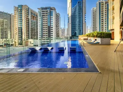 a swimming pool in a city with tall buildings at Bayz Tower, Business Bay in Dubai
