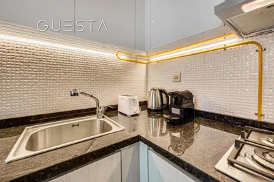 a kitchen with a sink and a counter top at Bayz Tower, Business Bay in Dubai