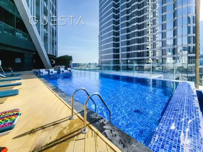 a large swimming pool on the roof of a building at Bayz Tower, Business Bay in Dubai