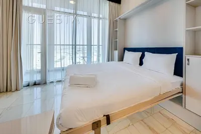 a large bed in a room with a large window at Bayz Tower, Business Bay in Dubai