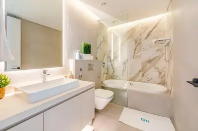 a white bathroom with a sink and a toilet at FAM Living - Stunning Modern Marina Apartment in Dubai