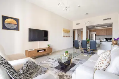 a living room with white furniture and a flat screen tv at Frank Porter - Eleganz 5 in Dubai