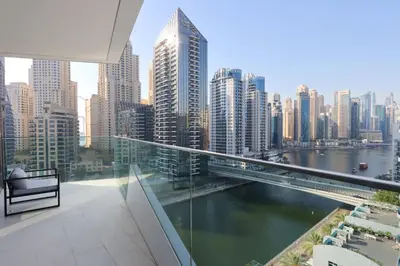 a balcony with a view of a river and a city at Deluxe 1BR Corner Suite with Marina Views in Dubai
