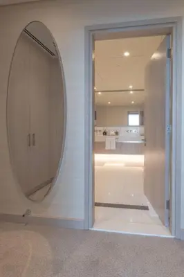 a room with a mirror on the wall and a bathroom at Palm Tower Luxury 1BR Sea View Suites with 5 Star Hotel Amenities in Dubai