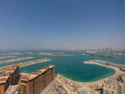 an aerial view of a harbor with a beach and buildings at Palm Tower Luxury 1BR Sea View Suites with 5 Star Hotel Amenities in Dubai