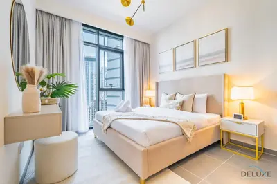 a bedroom with a large bed and a large window at Charming 1BR Apartment in Creek Edge Tower 1, Dubai Creek Harbor by Deluxe Holiday Homes in Dubai