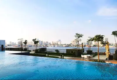 a swimming pool with a view of the city at Charming 1BR Apartment in Creek Edge Tower 1, Dubai Creek Harbor by Deluxe Holiday Homes in Dubai